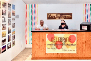 Two people sit behind a desk at the Wyandot County Fair