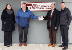 FCNB employees present a check to a hospital employee